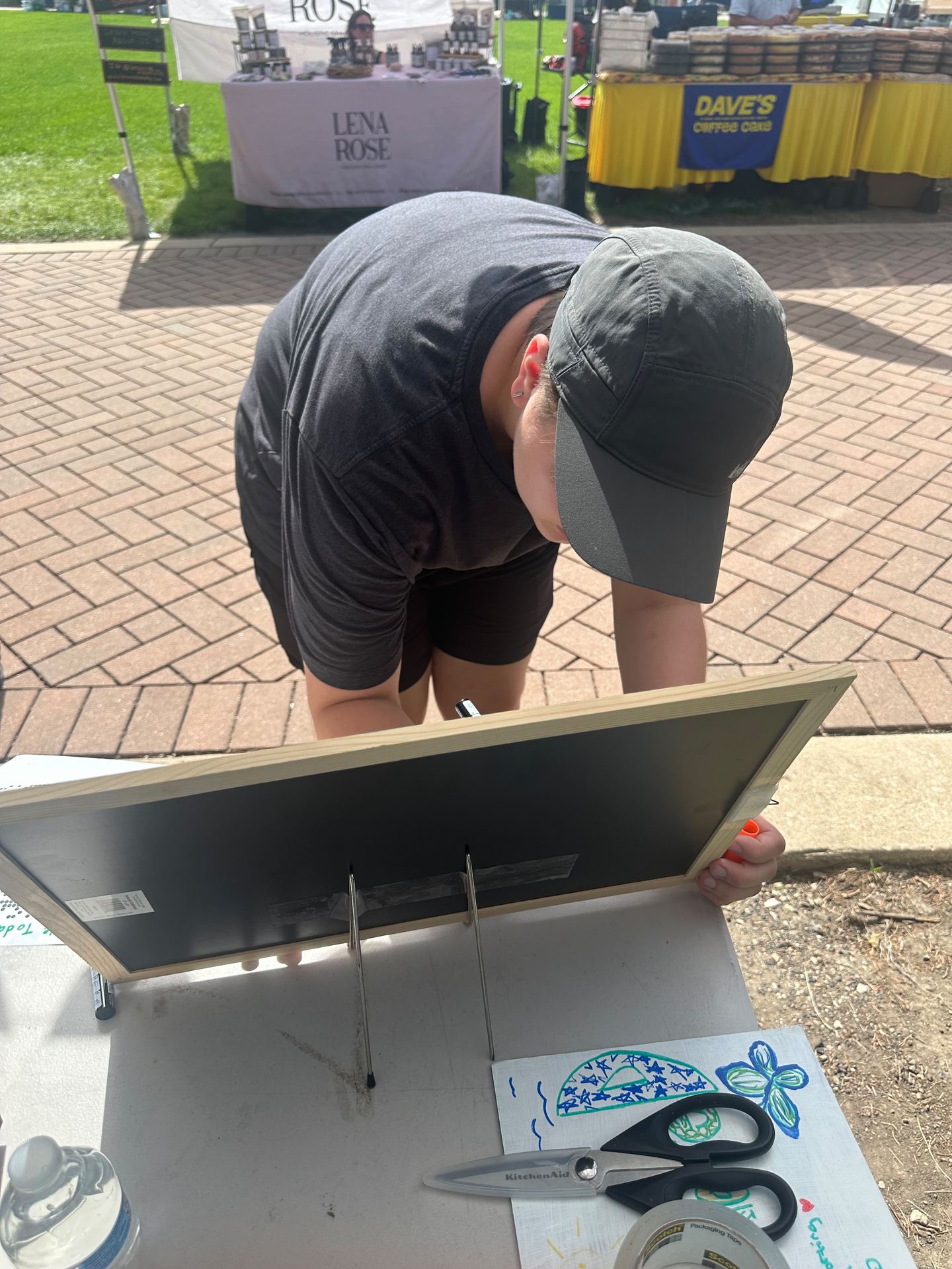 Another community member adding their signature to the pledge wall