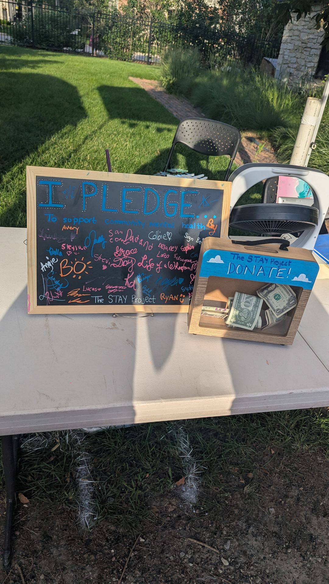 The pledge board and donation box on The STAY Project's table