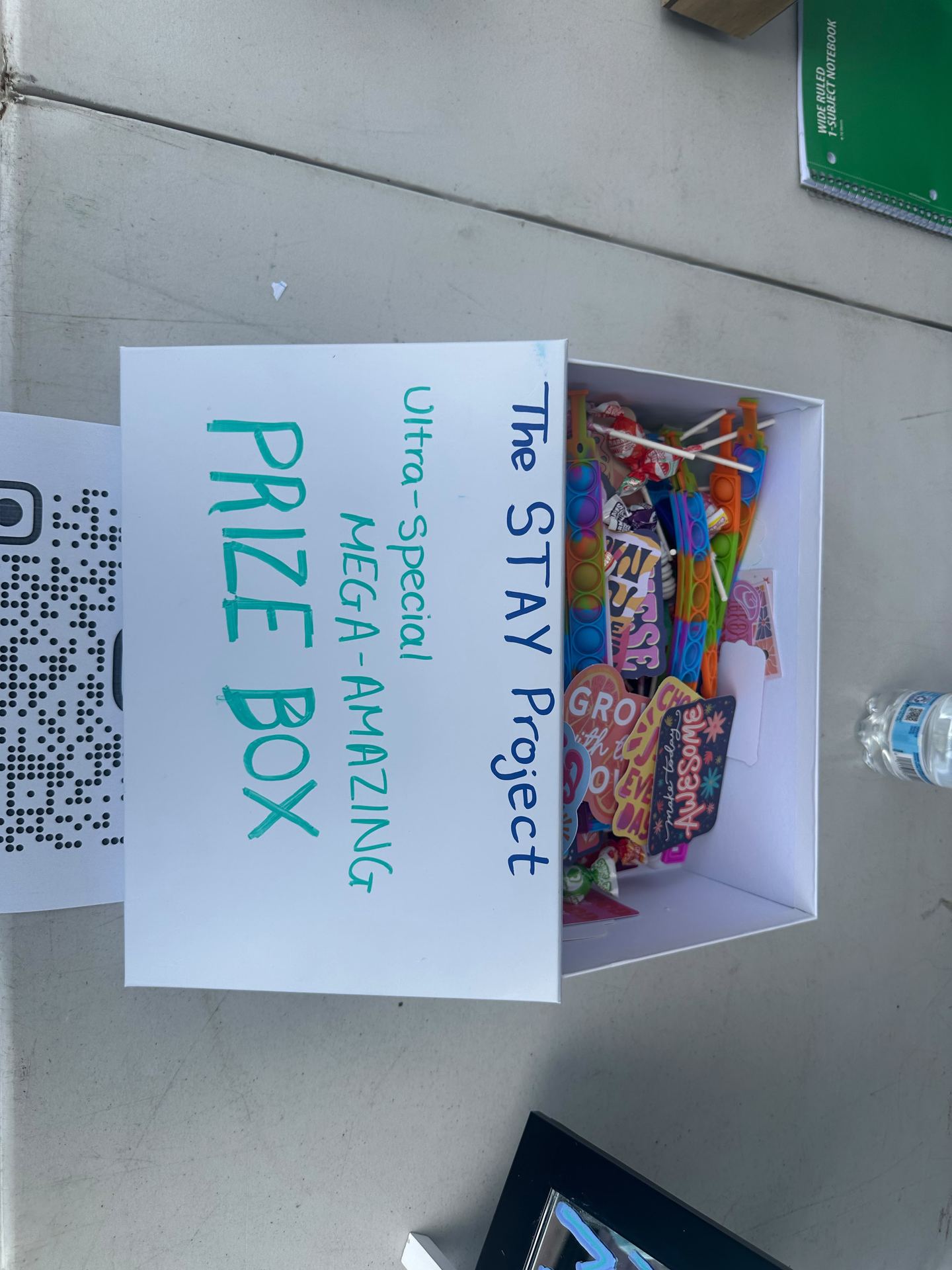 The 'Ultra-Special Mega-Amazing Prize Box' filled with fidgets and stickers at the booth